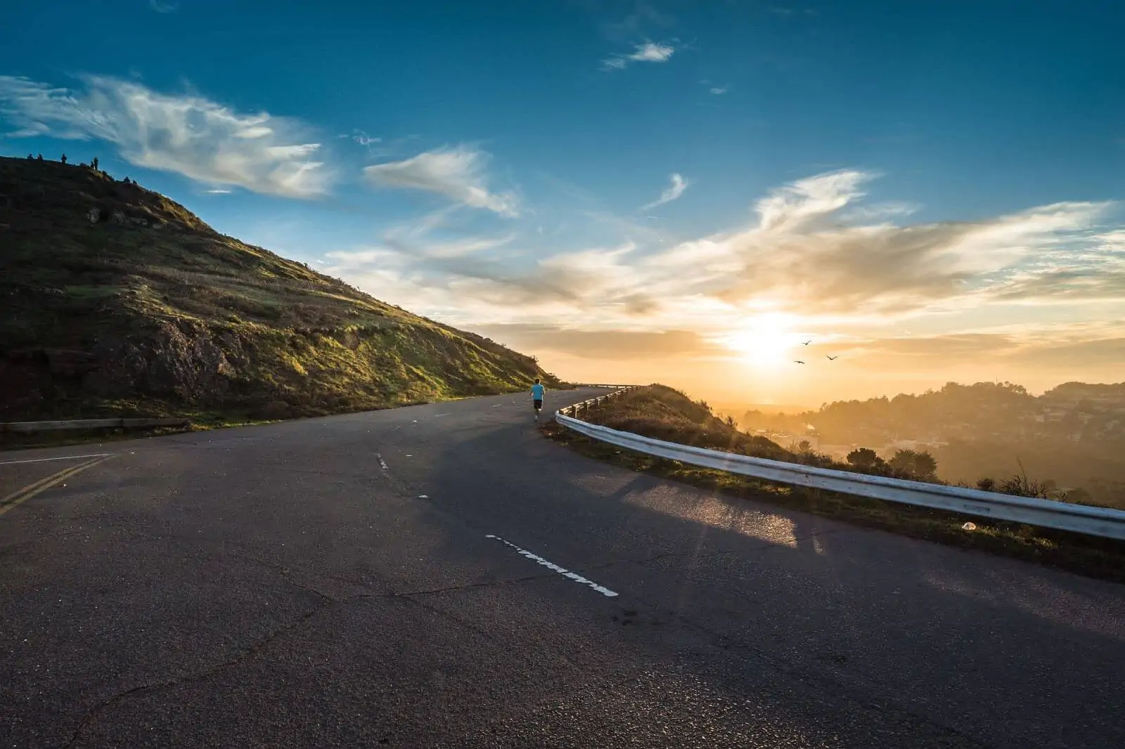 Person running up a hill. Photo by Joshua Sortino on Unsplash.